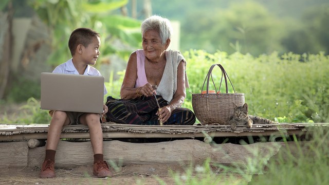 A boy sits outside with his grandmother in Thailand. Most Buddhists in Asia say you cannot be "truly" Buddhist if you do not respect elders. (Sutiporn Somnam/Getty Images)